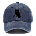 Owl perched on branch at night - Washed Cap