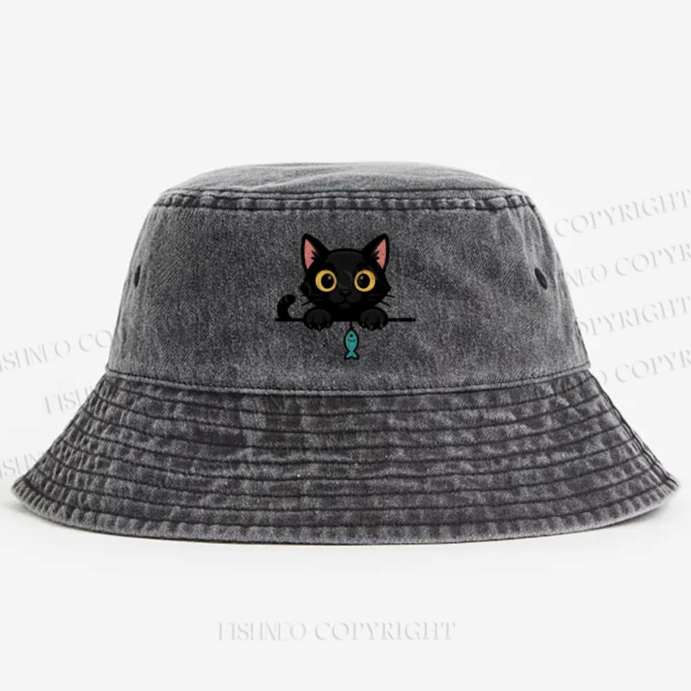 Midnight the black cat holding a tiny yarn ball between both paws while peeking Washed Bucket Hat