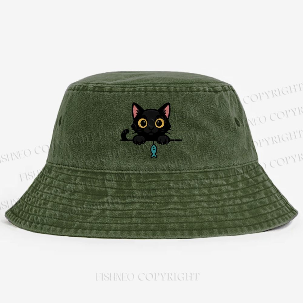 Midnight the black cat holding a tiny yarn ball between both paws while peeking Washed Bucket Hat