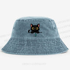 Midnight the black cat holding a tiny yarn ball between both paws while peeking Washed Bucket Hat